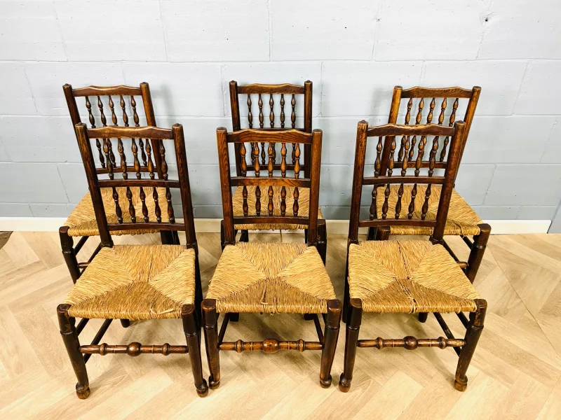 A set of six early 19th century oak Lancashire spindle back chairs with rush seats