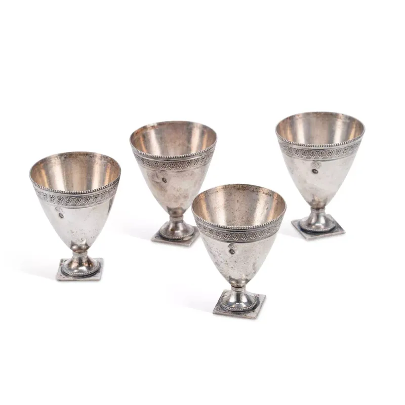 A Set Of Four Ottoman Silver Zarf Cups early 20th Century, of tapering cylindrical form with beaded borders, repeating decorative floral band