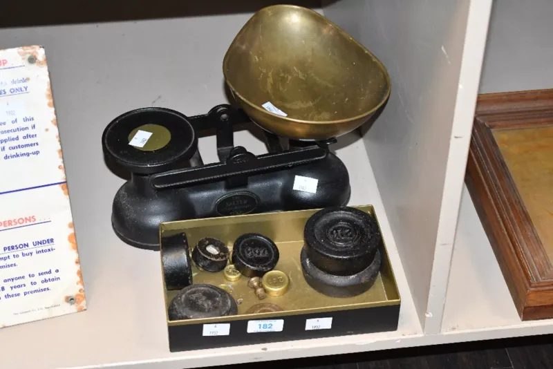 A vintage Salter brass and metal kitchen scale with brass weights, marked,