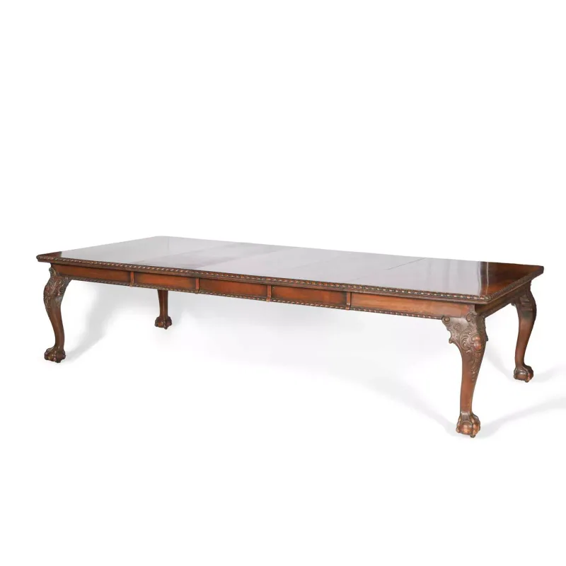 A George II Style Walnut Extending Dining Table early 20th Century, attributed to Waring & Gillow, with a gadrooned edge