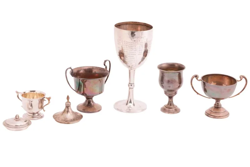A mixed collection of silver trophies, comprising a silver goblet, possibly by William Aitken, marks partially rubbed