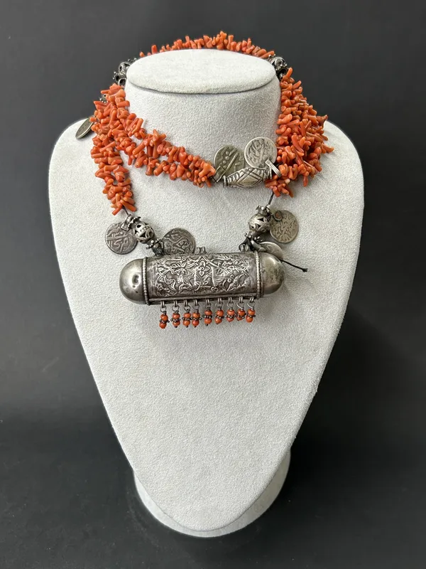 A vintage Central Asian white metal and coral necklace with a 'Hirz' (prayer box) pendant, approx. 13 1/2" long