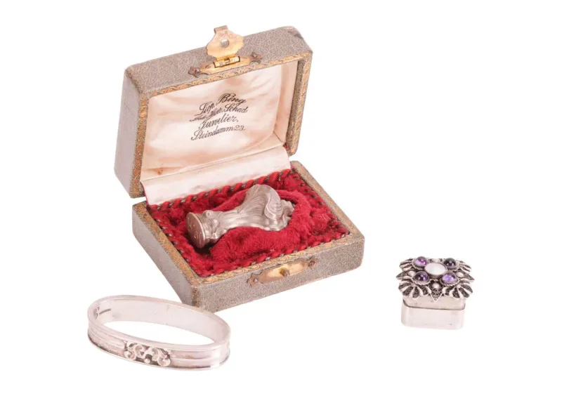 An Art Nouveau seal, a Georg Jensen napkin ring and a silver pill box, the ornate seal with initials 'RW', in fitted case from Leop