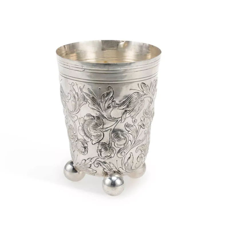 An 18th Century German Silver Beaker Augsburg, early 18th Century, maker's mark R.C., of tapering cylindrical form, embossed with foliate scrolls