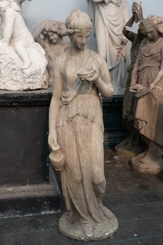 A classical style sculpture depicting Hebe The painted composite figure of Hebe carrying a ewer and a bowl