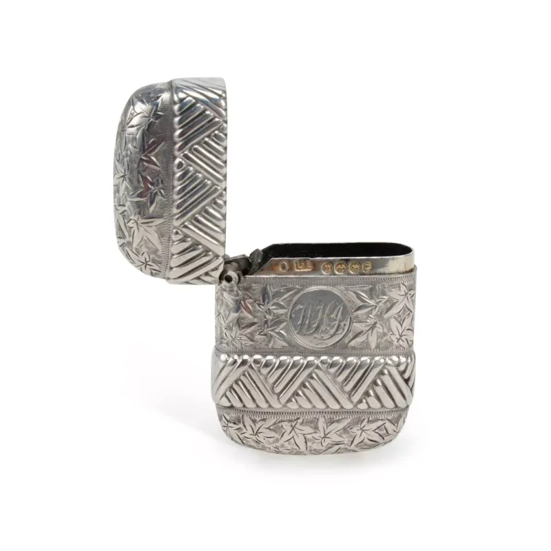 A Late Victorian Silver Vesta Case by Lawrence Emanuel, Birmingham 1887, of curved rectangular form with a hinged cover