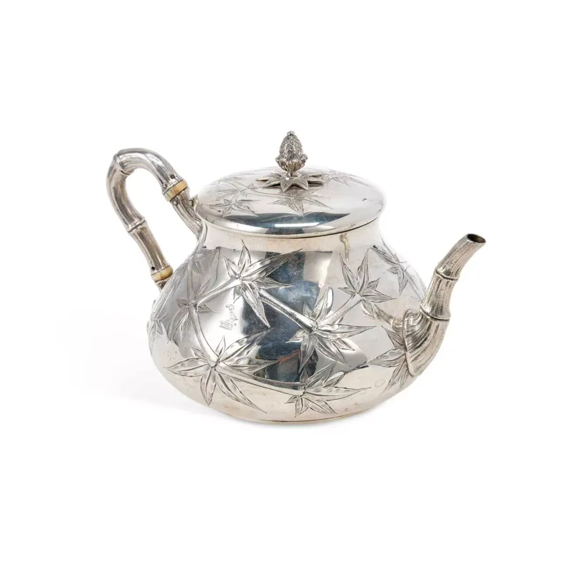 A Victorian Silver Chinoiserie Teapot § by Fenton Brothers (John Frederick Fenton & Frank Fenton), Sheffield 1874, of compressed round form with a hinged cover
