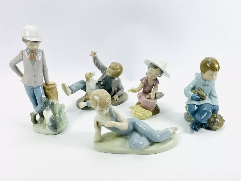 A collection of five Nao porcelain figurines to include 'Boy playing with Dog', model No.0278 (20.5cms wide x 10.5cms deep x 16.5cms deep)