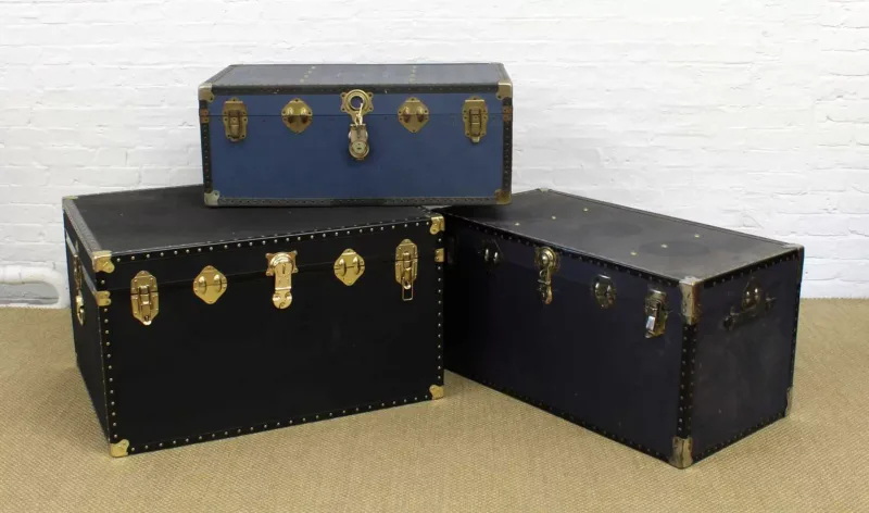 A Group of Vintage Travelling Trunks A Group of Vintage Travelling Trunks , three flat-topped and two domed, variously studded and brass or leather bound