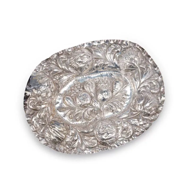 A German Silver Fruit Serving Plate 19th Century, of oval form repoussé decorated with fruit, scrolls and tulips within a crimped border.