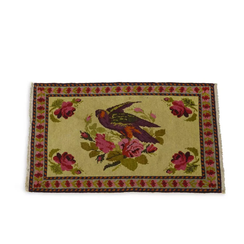 A Small Wool Rug In The Chinese Taste the pale field decorated with a bird perched amid flowering roses, within a rose-pattern border and narrow guard stripes