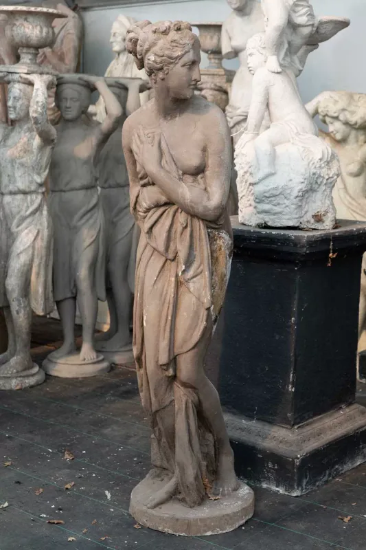 A sculpture of Venus Italica after the 1812 marble sculpture by Antonio Canova The composite sculpture with a brown painted finish