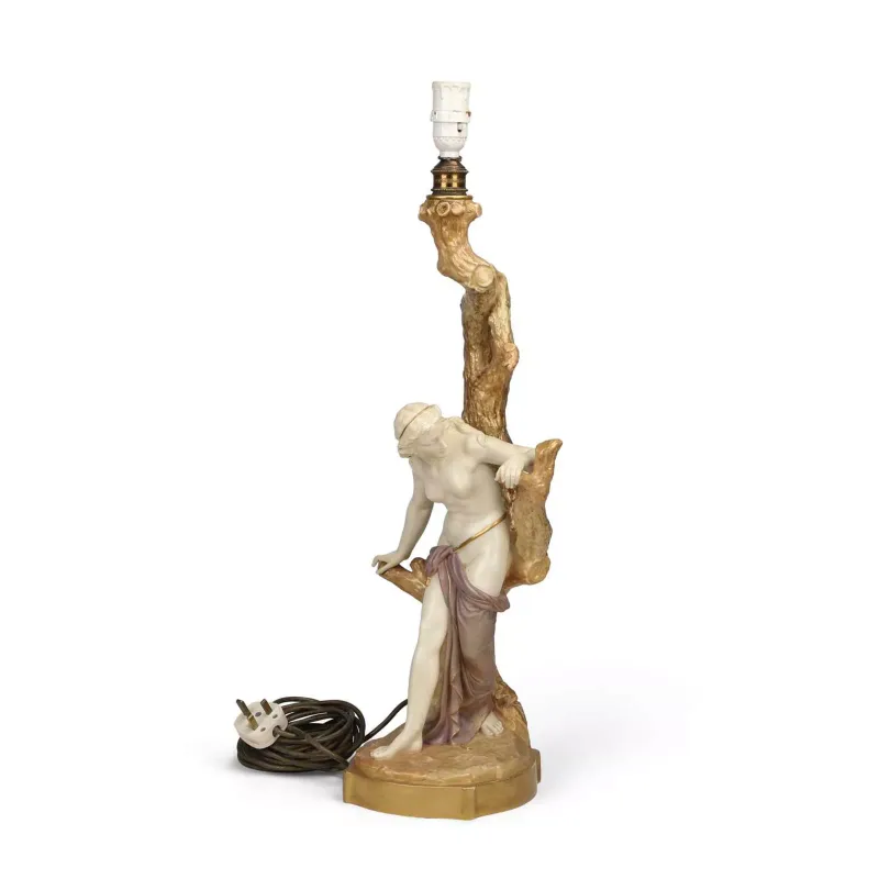 A Large Royal Worcester "Cricklite" Blush Ivory Porcelain Lamp Base modelled as a female nude resting against a tree stump