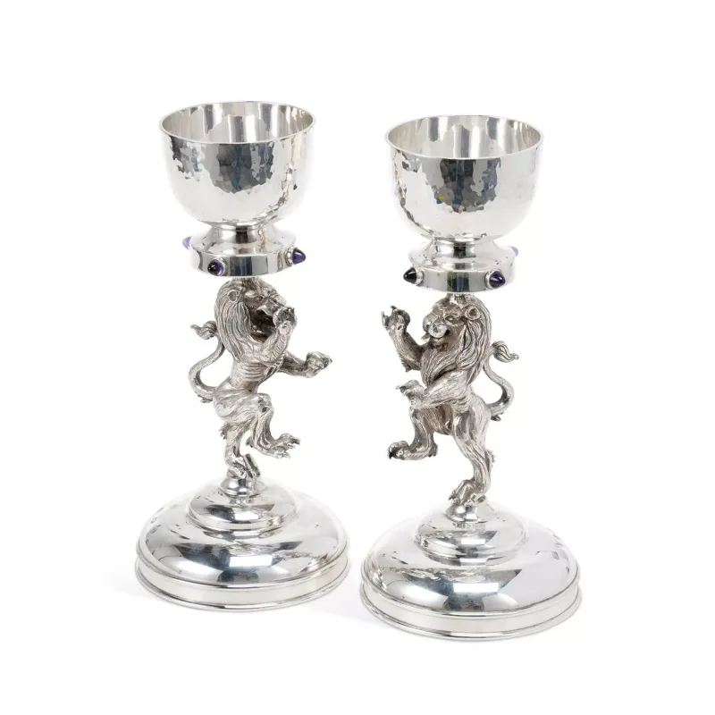 A Pair Of Elizabeth II Scottish Silver Figural Candlesticks by Hamilton & Inches, Edinburgh 2000, the stems cast as a pair of rampant lions