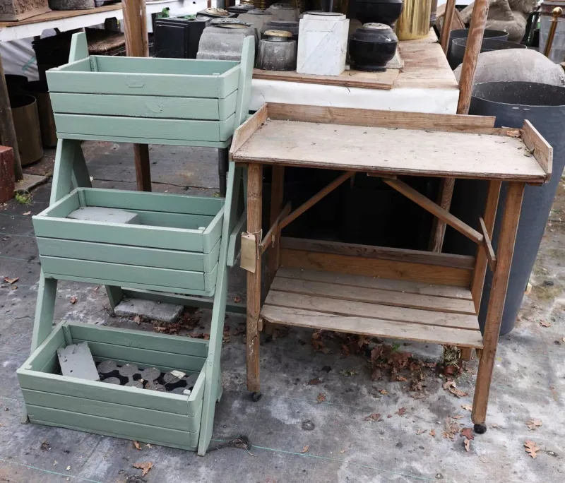 'Blooma', a three tier plant stand together with a potting table The pine plant stand with a green painted finish