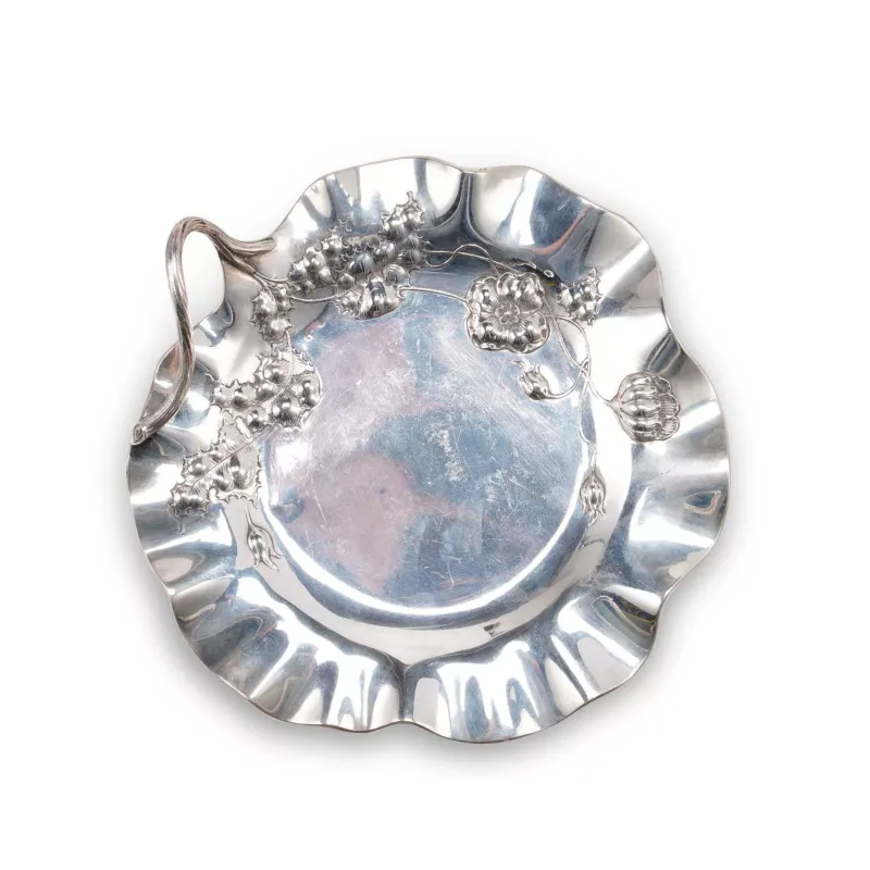 An Austrian Art Nouveau Silver Tray of shaped circular outline, in the form of a lily pad, embossed with stylised flowerheads and leaves