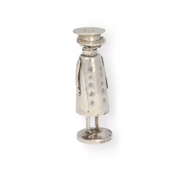 An Elizabeth II Silver Novelty Pepperette maker's mark Ww, London 1996, modelled as a standing figure in a double-breasted greatcoat and peaked cap