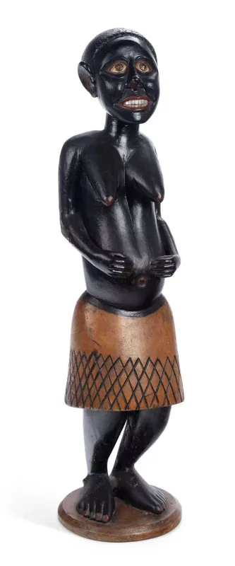 An African Carved And Painted Wood Figure Of A Woman standing with her hands to a swollen belly, the body ebonised