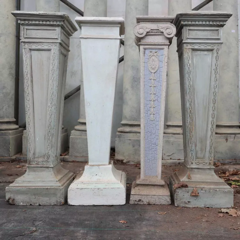 A pair of Georgian style torchères and two further torchères All in painted composite of square section with waisted supports and stepped bases The pair