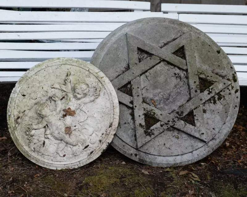 Two fibreglass plaques One plaque depicting the Star of David, the other with two putti The largest