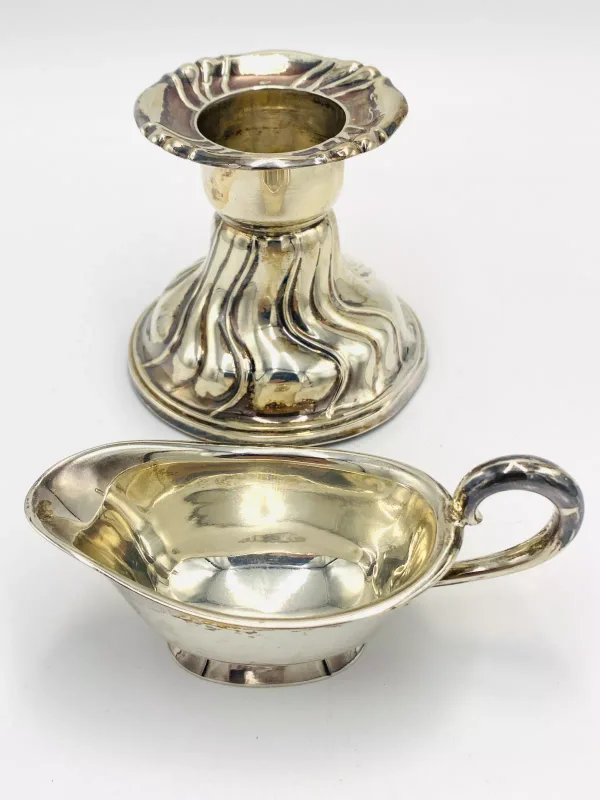 A weighted silver candlestick stamped 800; together with a silver milk jug