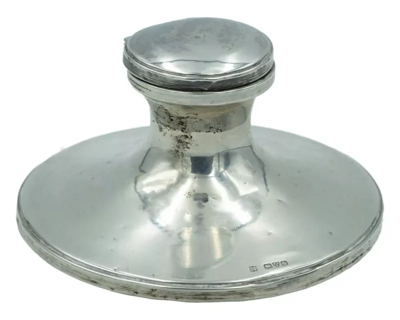A silver capstan inkwell by James Deakin & Sons