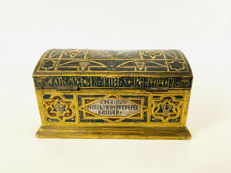 An early 20th century Continental dome top Gothic style table casket with carved, gilt and painted decoration