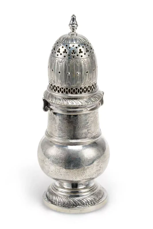 A Dutch Silver Sugar Caster 18th Century, of baluster form with a domed pierced cover, gadrooned borders, engraved with winged trumpeters