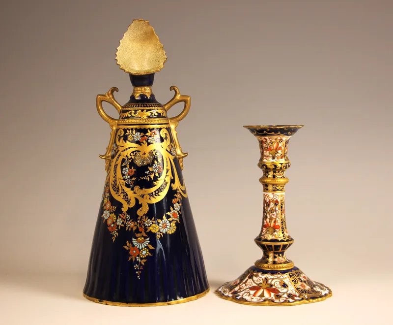 A Royal Crown Derby twin handled stem vase, late 19th century, of conical form with ornate spur handles and shaped neck cowl