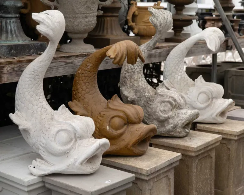A group of four ornamental dolphins The large composite dolphins in the classical style