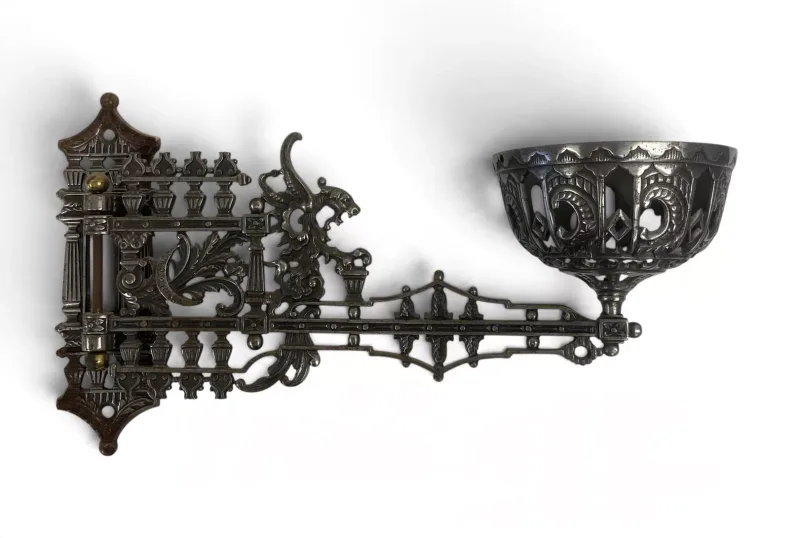 A pair of 19th century cast metal wall mounted swing-arm gas burner wall sconces with one missing gas burner