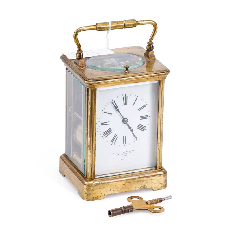 A French Brass Striking Carriage Clock late 19th Century, the corniche case with a swing handle above a bevelled glass escapement aperture and a repeat button