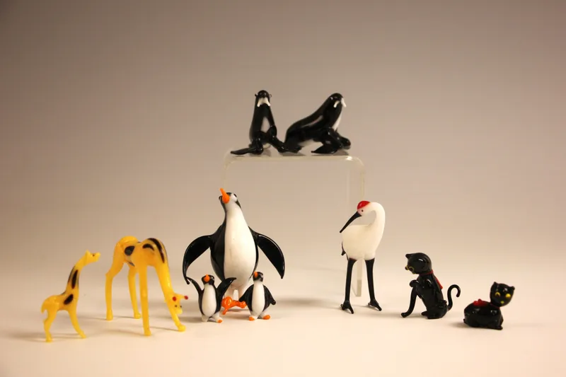 A collection of early Murano polychrome miniature glass animals, comprising: a penguin (missing one toe) and chicks, a stork, two seals