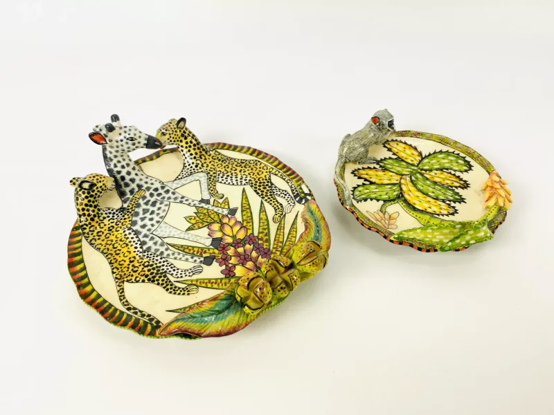Two items of Ardmore Studio pottery to include a shallow dish with applied cheetah and giraffe decoration