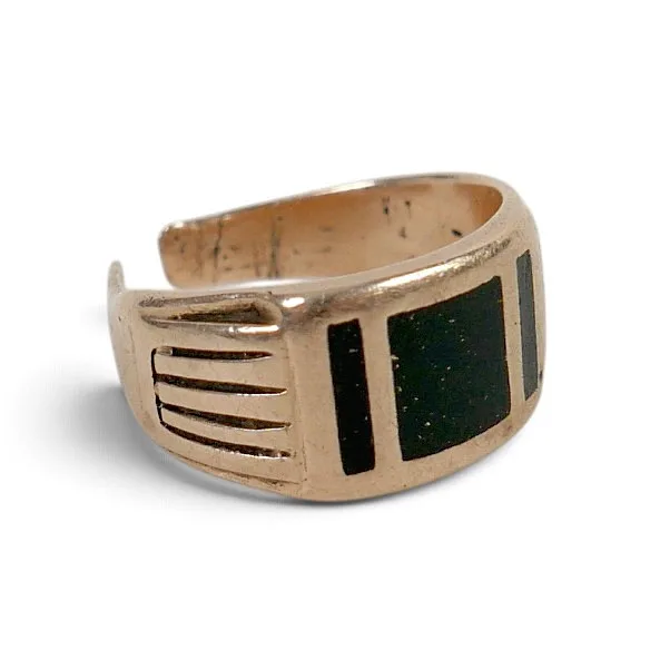 A Gold Ring Decorated with a Black Square and Rectangles