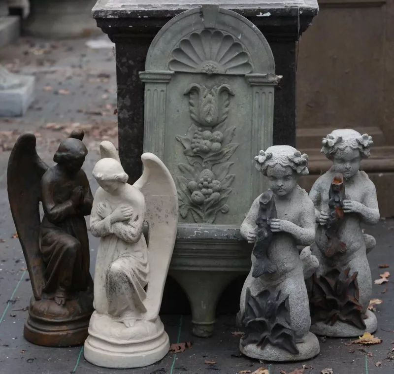 A small wall fountain together with two mermaid fountains and two sculptures of angels All five pieces in painted composite The fountain