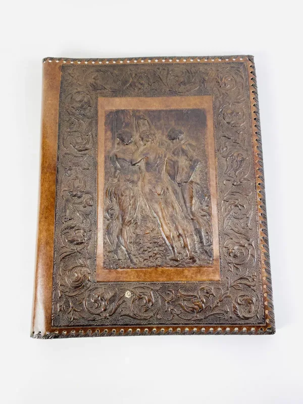 A good quality Italian leather bound photo/scrap album, the front with embossed decoration of the three graces