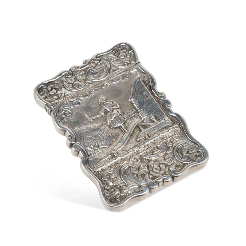 A Victorian Silver Card Case by Edward Smith, Birmingham 1848, of shaped rectangular form with a hinged cover, repoussé decorated with foliate scrolls