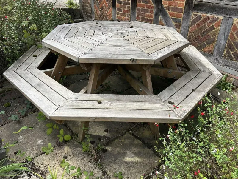 An octagonal picnic table The table with conforming benches to the outside