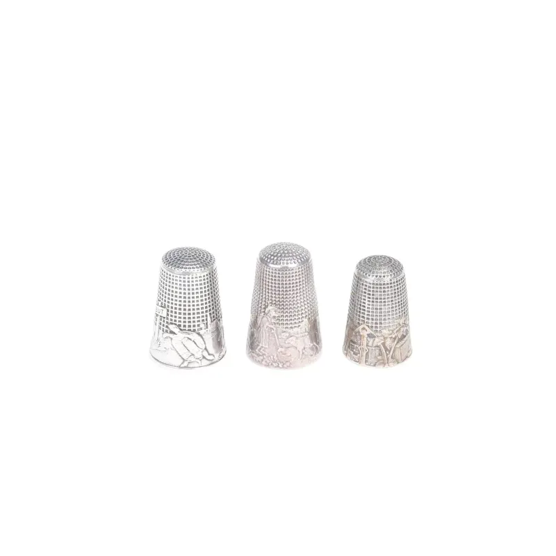 A French Silver Thimble, Together With Two Further Silver Thimbles comprising the first chased with scene of a shepherdess and flock