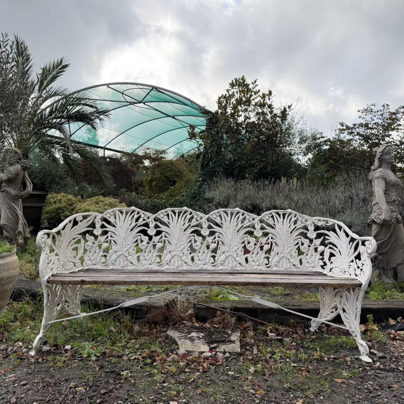 An aluminium Coalbrookdale style garden seat or bench The corn and poppy patterned bench with cream painted finish and wooden slats