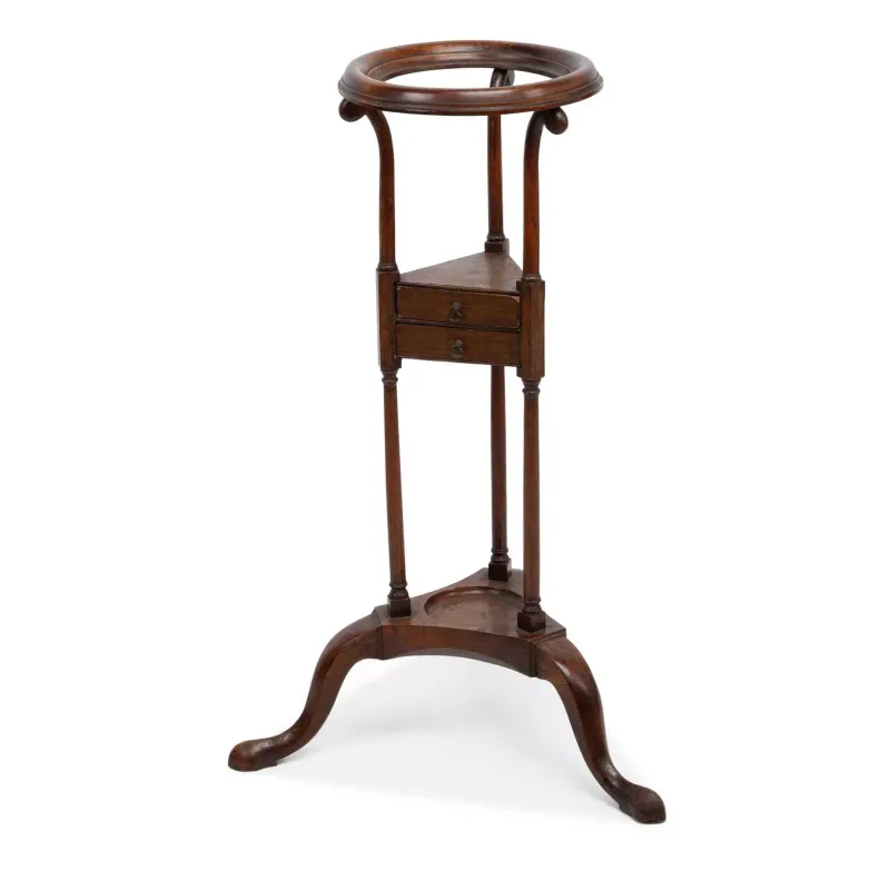 A George III Mahogany Wig Stand circa 1780, the circular ring top upon three scrolled uprights above a shaped triangular tier fitted with two drawers