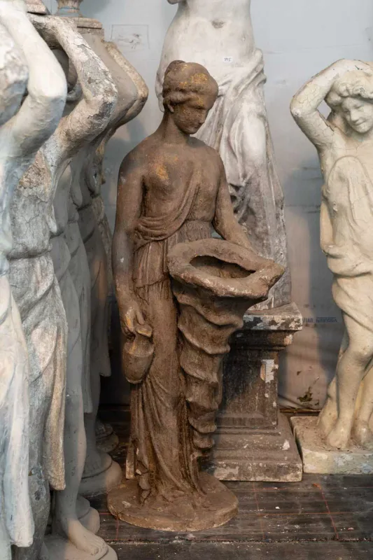 A classical style sculpture The sculpture in the form of a semi-clad female figure holding a cornucopia