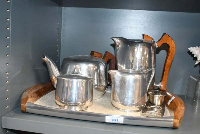 A mid 20th-century Picquot Ware magnailium tea and coffee service, featuring wood detailing, to include a coffee and tea pot, serving tray