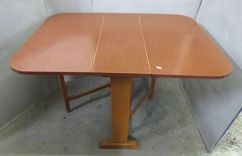 Mid Century Blonde Wood Drop Leaf Table with formica top, folding legs, trestle end supports approx.