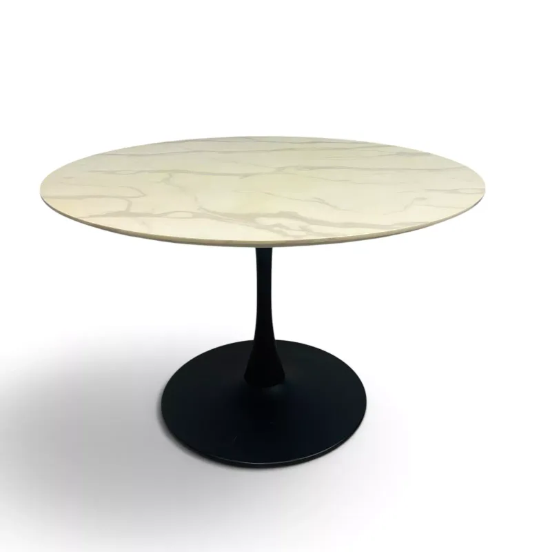 A retro styled dining table with circular faux marble top and black powder coated metal base, in the 'Tulip Table' style