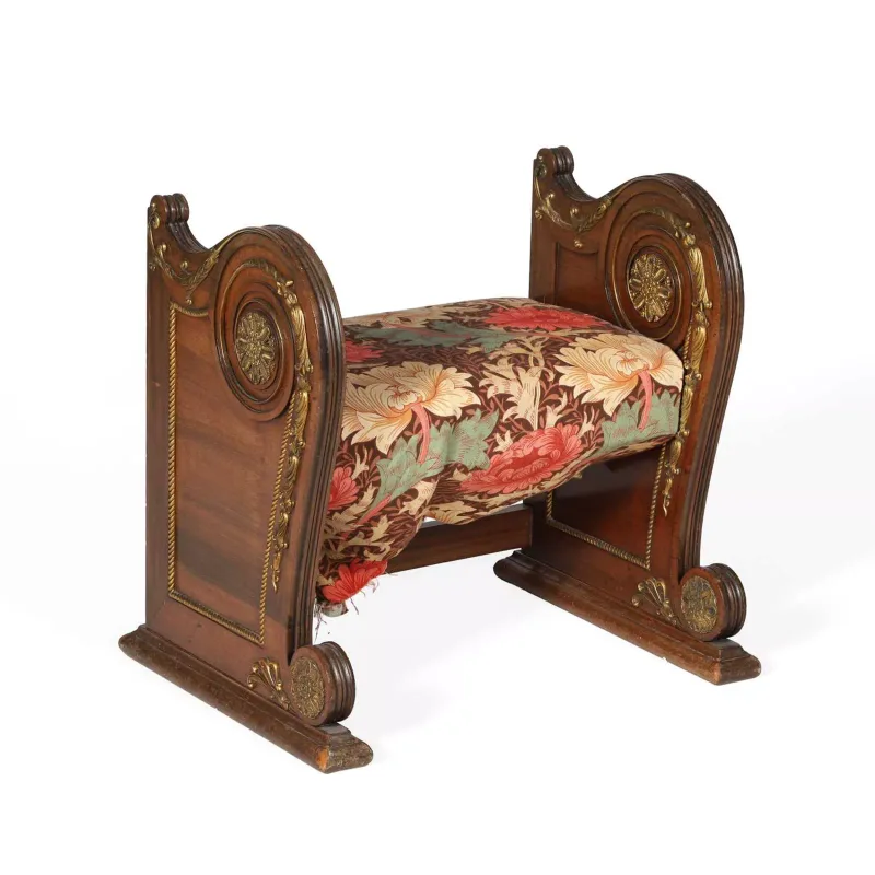 A Mahogany And Gilt Metal Mounted Stool the scrolled gondola ends applied with foliate mounts and rosette paterae within roundels, the upholstered seat between