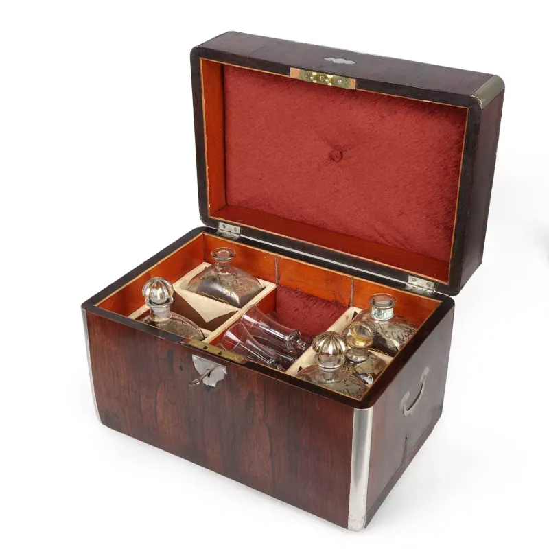 A Rosewood Decanter Box mid-19th Century, of rectangular form with rounded angles, bound at the angles and edges in plated metal