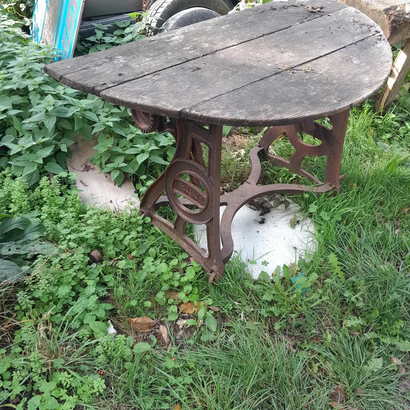 Early 20th century cast iron industrial table base advertising Ewebank with a wooden demi lune plank top