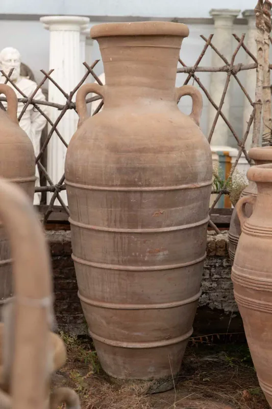 A large North African terracotta storage jar The jar of cylindrical form with lug handles and ring turned decoration Approximately